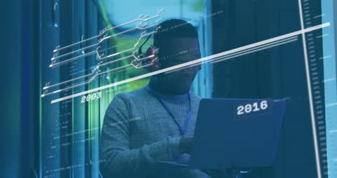 IT Technician Analyzing Data by Server Racks