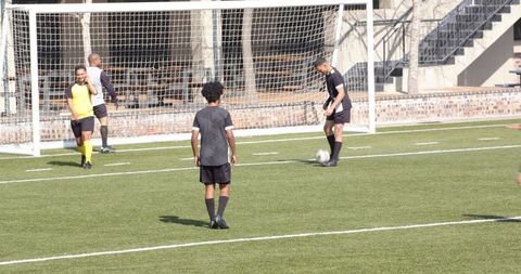 Youth Soccer Players Strategizing for Goal on Sunny Day