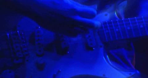 Blue Stage Electric Guitar Close-Up Hands Strumming Pickups and Neck Live Music Promotion