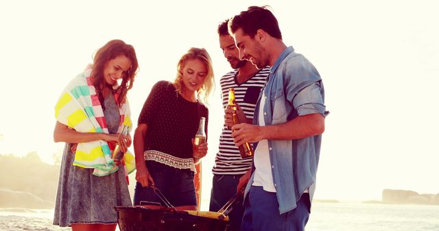 Group of Friends Enjoying Beach Barbecue During Sunset - Download Free Stock Images Pikwizard.com