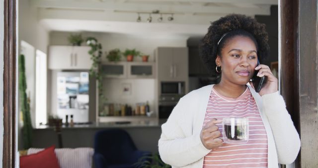 Woman Talking on Phone in Modern Kitchen Holding Coffee Cup - Download Free Stock Images Pikwizard.com