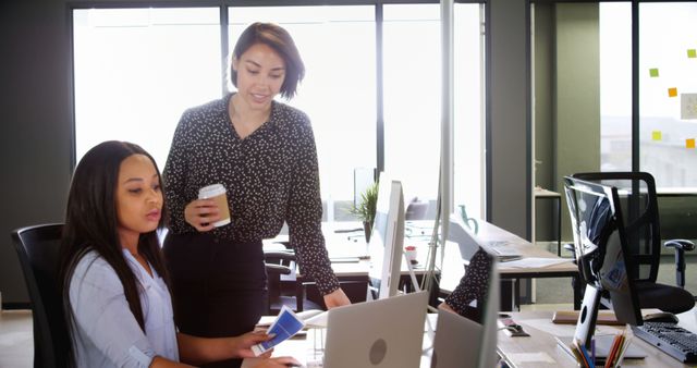 Two Businesswomen Discussing Work in Office Environment - Download Free Stock Images Pikwizard.com