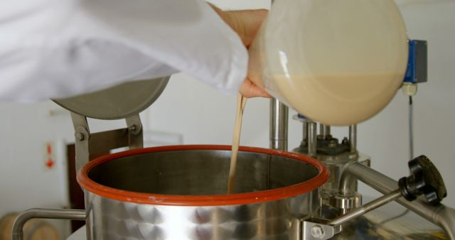 Scientist Pouring Liquid into Industrial Equipment for Experiment - Download Free Stock Images Pikwizard.com