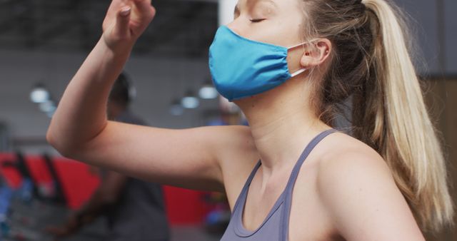 Woman Exercising at Gym Wearing Face Mask - Download Free Stock Images Pikwizard.com