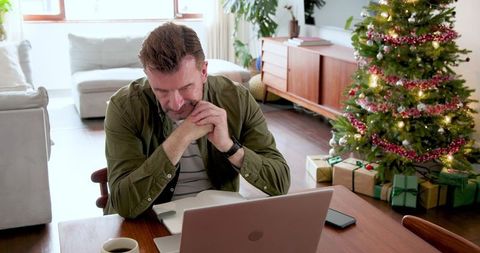 Senior man working online in festive home office setting