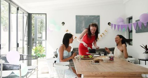 Diverse Friends Celebrating Birthday with Cake in Bright Dining Room