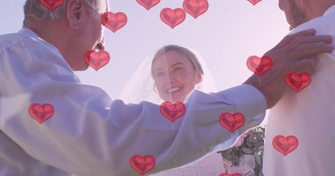Couple Wed Outdoors with Elderly Officiant and Heart Motif