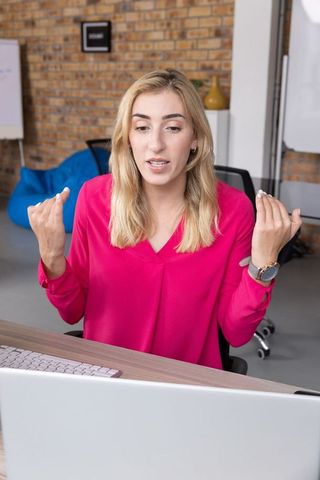 Motivated Professional Woman Gesturing During Virtual Meeting