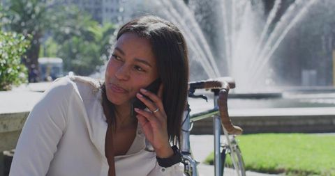Urban Lifestyle Woman Relaxing with Smartphone in Scenic Park