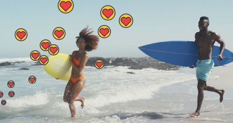 Joyful Couple with Surfboards Running on Sunny Beach