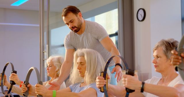 Senior Women Practicing Pilates with Instructor in Modern Gym - Download Free Stock Images Pikwizard.com