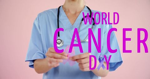 Medical Professional Holding Pink Ribbon for World Cancer Day