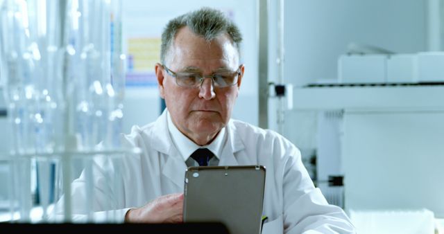 Mature Scientist Using Tablet Computer in Laboratory - Download Free Stock Images Pikwizard.com