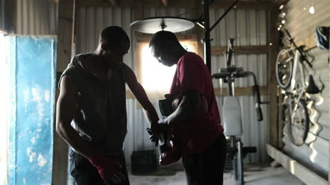 Men Preparing for Boxing Training Session in Rustic Gym