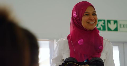 Confident Female Pilot Training Kids on Electric Car Technology