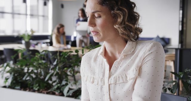 Thoughtful Businesswoman Sitting in Modern Office Environment - Download Free Stock Images Pikwizard.com