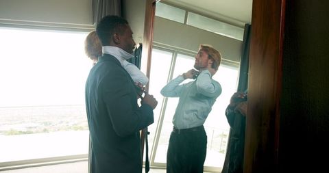 Groom and best man getting ready for wedding ceremony