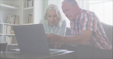 Senior Couple Engaged in Learning on Laptop Together