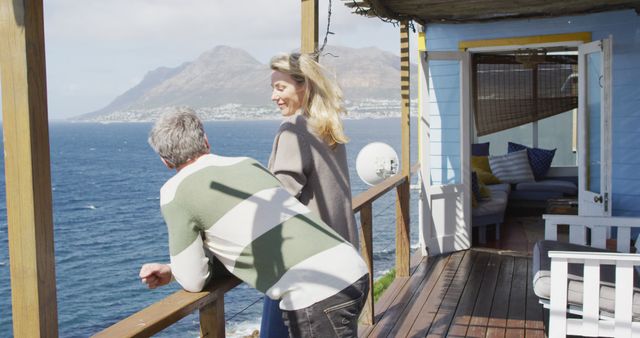 Couple Relaxing on Oceanfront Deck Enjoying Scenic View - Download Free Stock Images Pikwizard.com