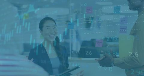 Diverse team meeting seated pensively behind finance technology holograms