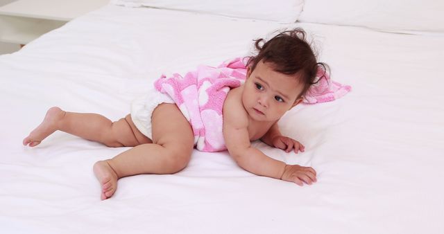 Cute baby on bed looking around