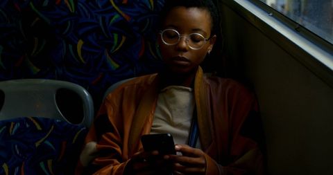 Young woman using smartphone on public transport bus