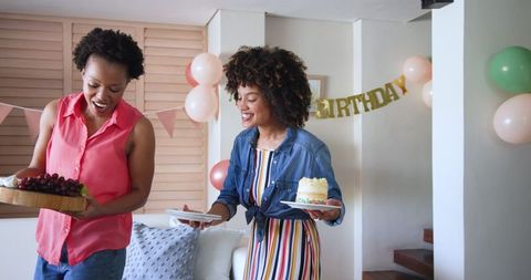 Happy Female Couple Celebrating Birthday with Cake Indoor