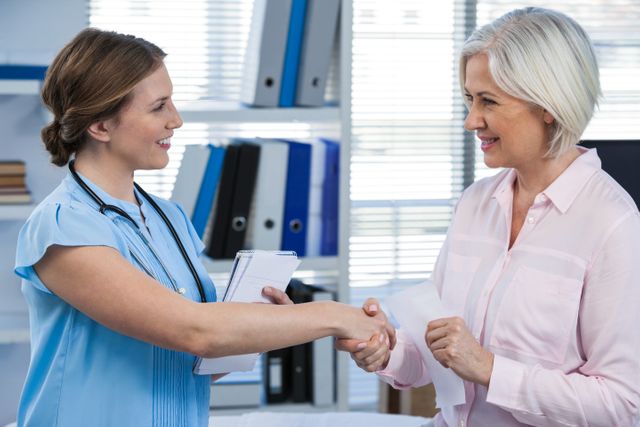 Doctor shaking hands with senior patient signifies trust and good communication in a healthcare setting. Useful for illustrating themes of medical consultations, patient care, healthcare relationships, and professional medical services. Ideal for healthcare websites, medical blogs, and informational brochures.