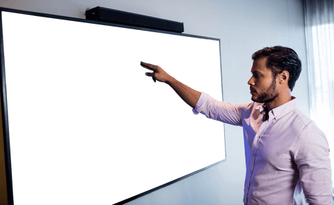 Business professional pointing at transparent screen
