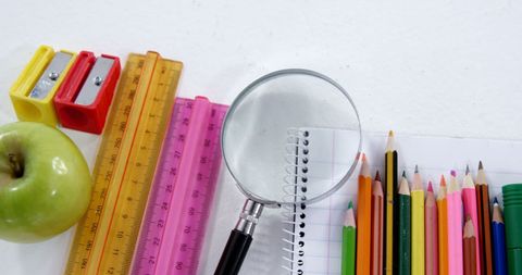 Colorful school supplies with apple for educational learning