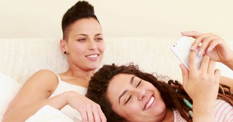 Couple Relaxing Together Sharing Smartphone Joy