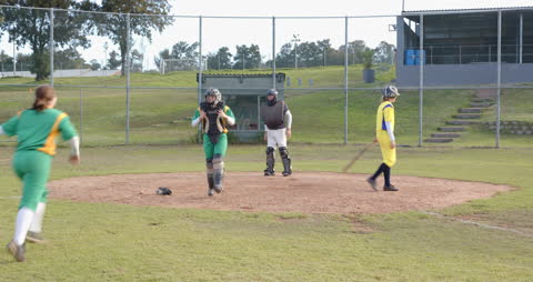 Female Softball Players Practicing on Field