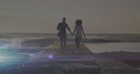 Couple Holding Hands on Ocean Walkway at Sunset - Download Free Stock Images Pikwizard.com