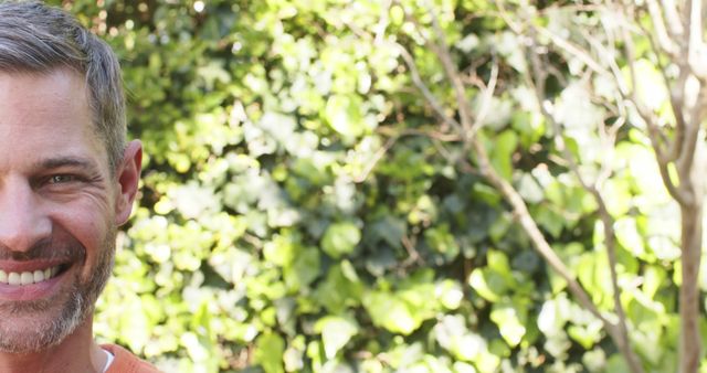 Smiling Man Outdoors in Front of Greenery - Download Free Stock Images Pikwizard.com