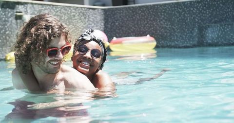Diverse Couple Enjoying Sunny Pool Day in Leisure