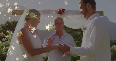 Outdoor wedding ceremony with floral decor under wooden arch