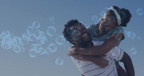 Joyful African American Couple with Digital Bubbles on Clear Day