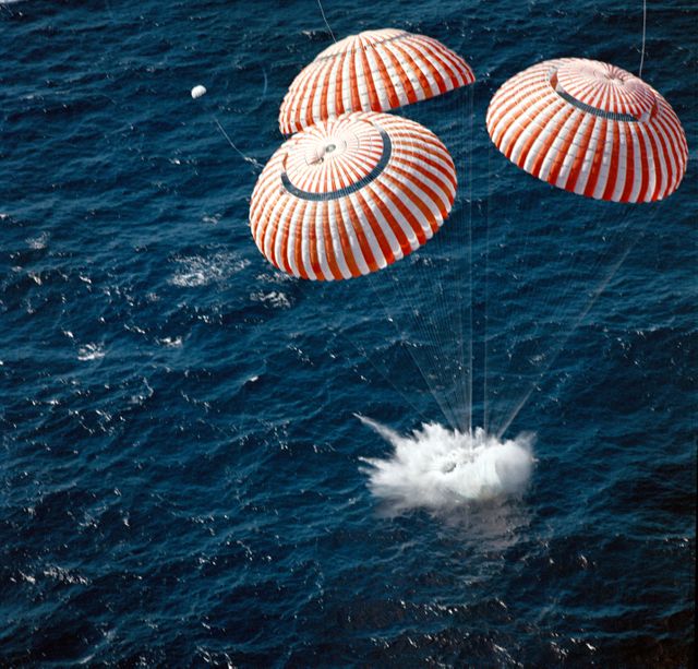 Astronauts aboard the Apollo 16 Command Module utilize parachutes to splashdown in the central Pacific Ocean near Christmas Island. This iconic moment concludes their successful lunar landing mission on April 27, 1972. Ideal for use in historical documentaries, space exploration articles, educational materials focusing on NASA missions, or any content celebrating milestones in human spaceflight.