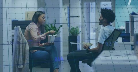 Colleagues Analyzing Financial Data with Digital Overlay