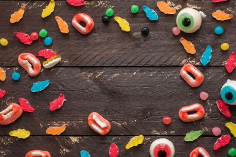 Colorful halloween candy assortment on rustic wood