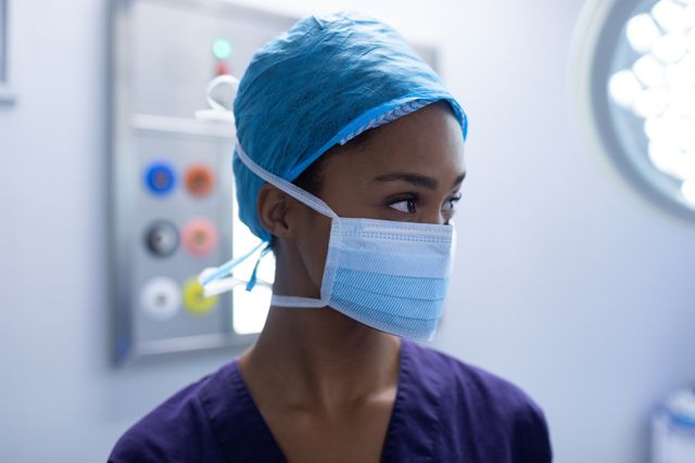 Young female surgeon standing in operation theater at hospital