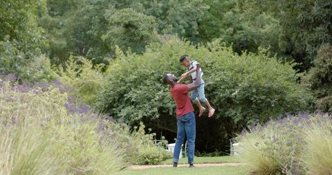 Father Lifting Son Outdoor Familial Bond and Joyful Connection