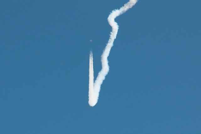 Jet engine releasing distinct contrail while testing sonic boom variations, perfect for illustrating aerospace technology, aviation advancements, and scientific research fields. Use in articles or educational materials discussing aerospace engineering, flight demonstrations, or NASA projects.