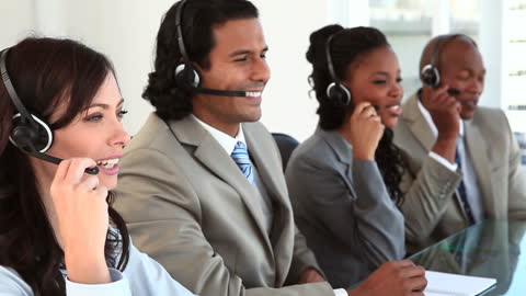 Diverse Call Center Team Collaborating in Bright Office