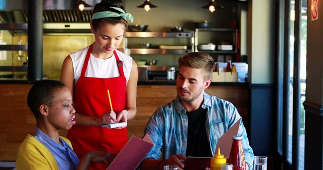 Diverse Friends Ordering Food in Trendy Cafe with Friendly Waitress - Download Free Stock Images Pikwizard.com