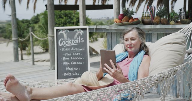 Senior Woman Relaxing with Tablet on Tropical Beach - Download Free Stock Images Pikwizard.com