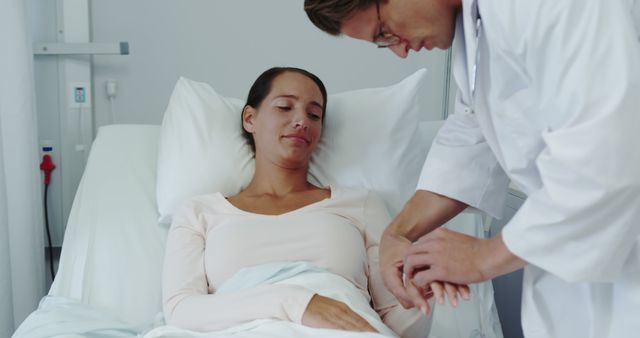 Doctor Checking Female Patient's Pulse in Hospital Bed - Download Free Stock Images Pikwizard.com