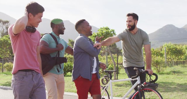 Group of friends having fun and enjoying time together outdoors in a sunny setting. Perfect for concepts related to friendship, outdoor activities, leisure time, and diverse communities.