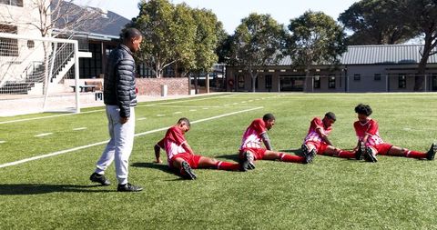 Young Soccer Team Practicing Drills on School Field