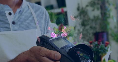 Florist accepting contactless payment using pos terminal with holographic network icons